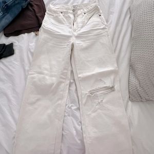 Reformation white denim jeans with a rip